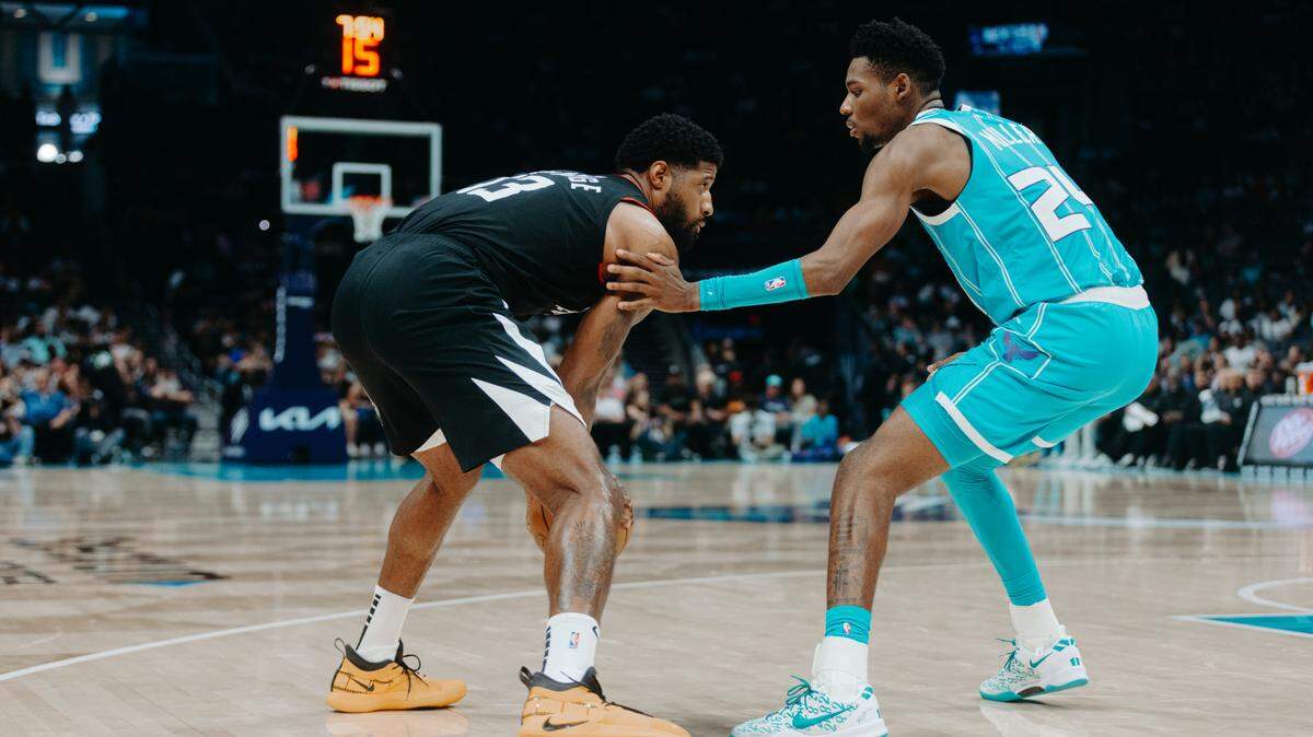 Charlotte Hornets rookie Brandon Miller (24) guards LA Clippers star Paul George during Sunday night’s game at Spectrum Center.