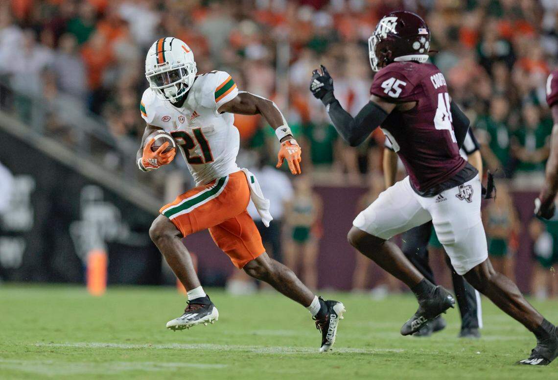 Miami Hurricanes running back Henry Parrish Jr. (21) attempts to out run Texas A&M Aggies linebacker Edgerrin Cooper (45) in the second half at Kyle Field, Bryan College Station, Texas on Saturday, September 17, 2022.