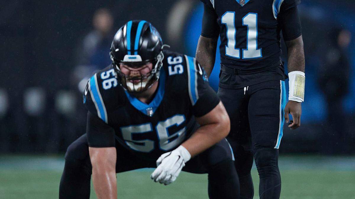Carolina Panthers quarterback PJ Walker (11) lines up behind center Bradley Bozeman (56) during a November game against the Atlanta Falcons in Charlotte. (AP Photo/Brian Westerholt)