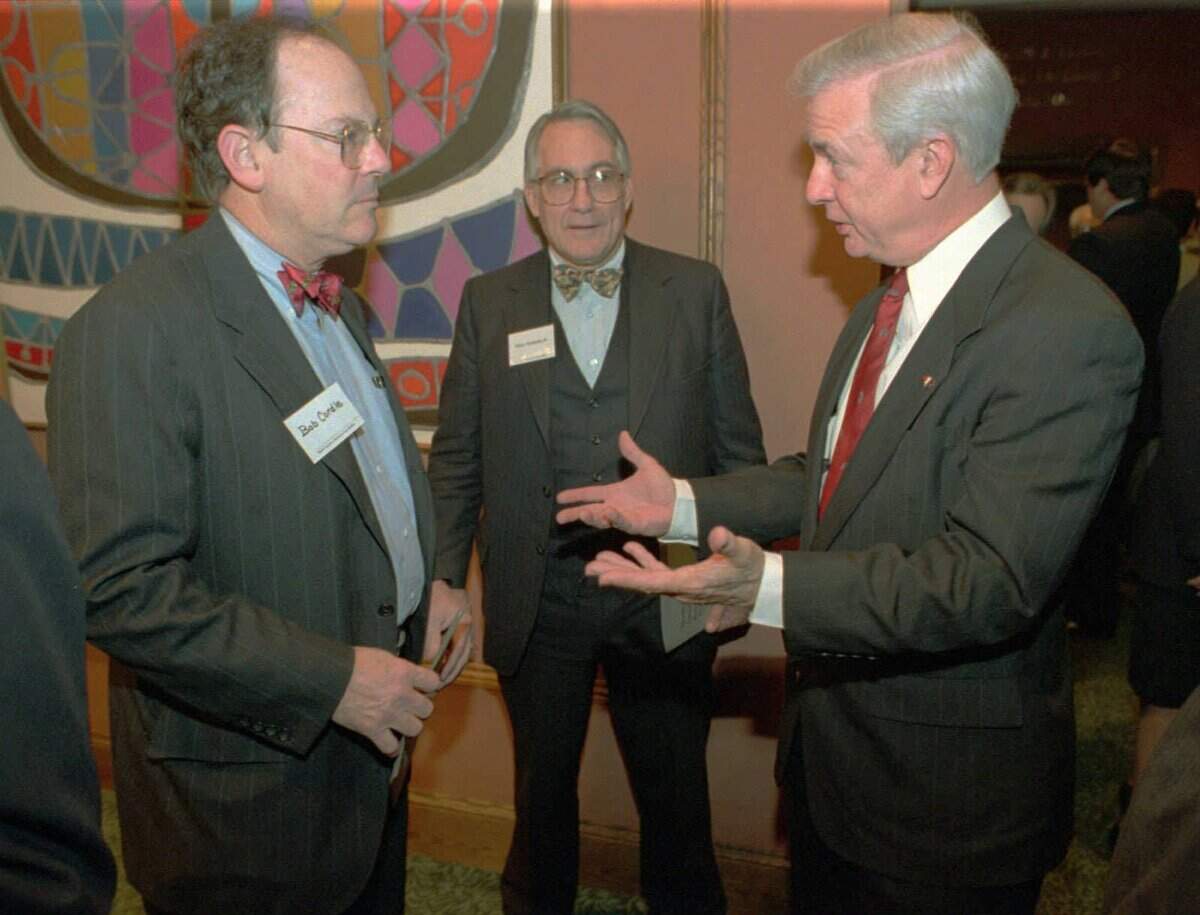 Gov. Jim Hunt (right) talks to Bob Cordle (left) and Osborne Ayscue Jr. in the lobby before the N.C. Business Roundtable session in January 1995 at the Adams Mark Hotel.