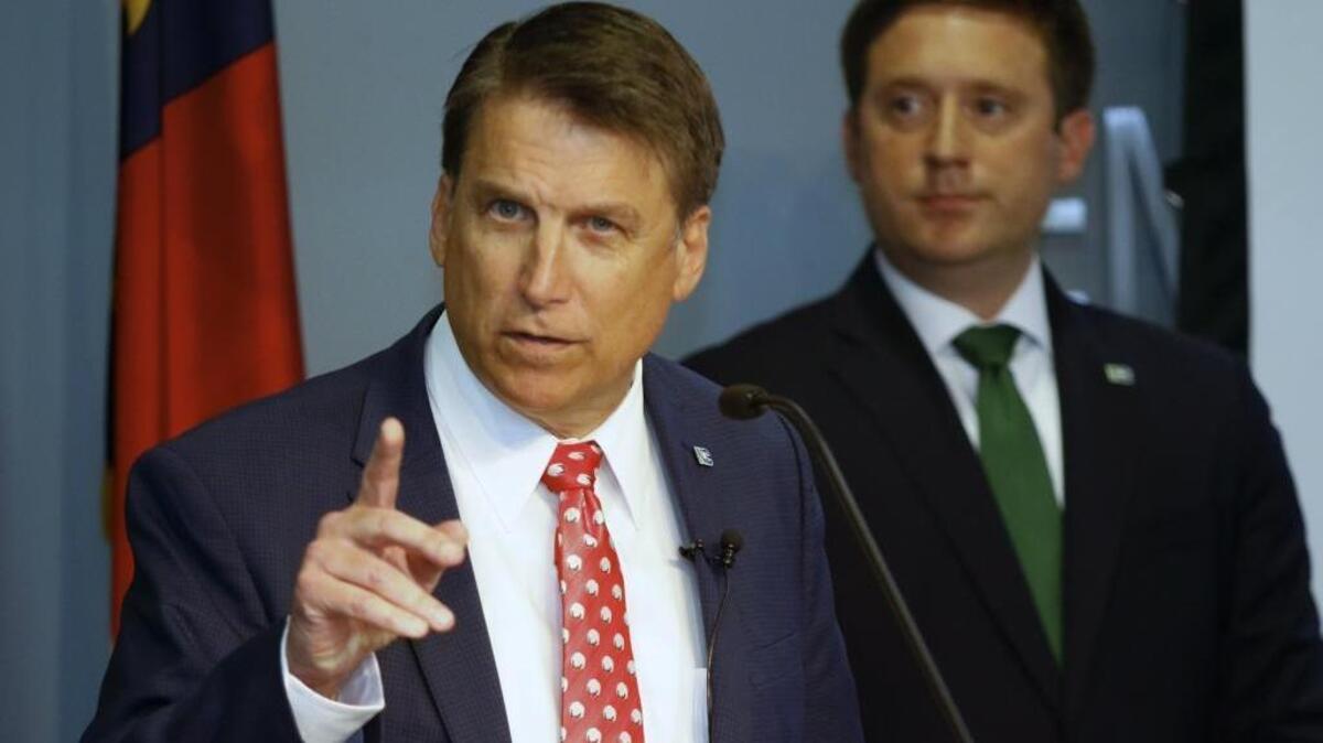 From left, N.C. Governor Pat McCrory announces his 2016-2017 state budget as Budget Director Andrew Heath listens during a press conference Friday morning, April 22, 2016, at the North Carolina National Guard Joint Task Force headquarters in west Raleigh.