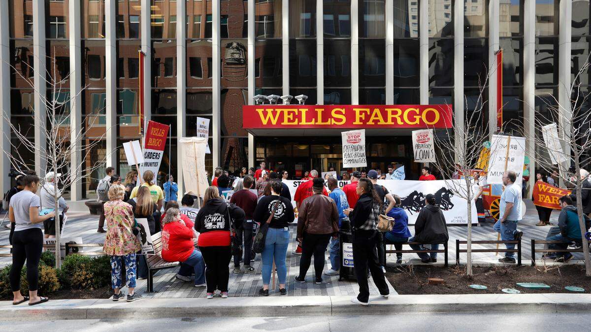 Protesters rally outside the Wells Fargo bank downtown branch Tuesday in Des Moines, Iowa. In a settlement announced last week, Wells Fargo will pay $1 billion to federal regulators to settle charges tied to misconduct at its mortgage and auto lending business, the latest punishment levied against the banking giant for widespread customer abuses.