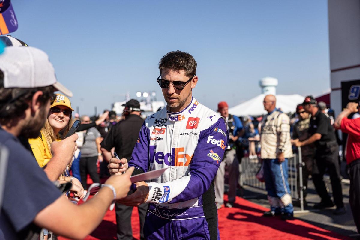 Denny Hamlin signs autographs before the Coca-Cola 600 in Concord, N.C., on Sunday, May 29, 2022.