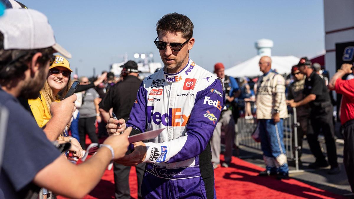 Denny Hamlin signs autographs before the Coca-Cola 600 in Concord, N.C., on Sunday, May 29, 2022.