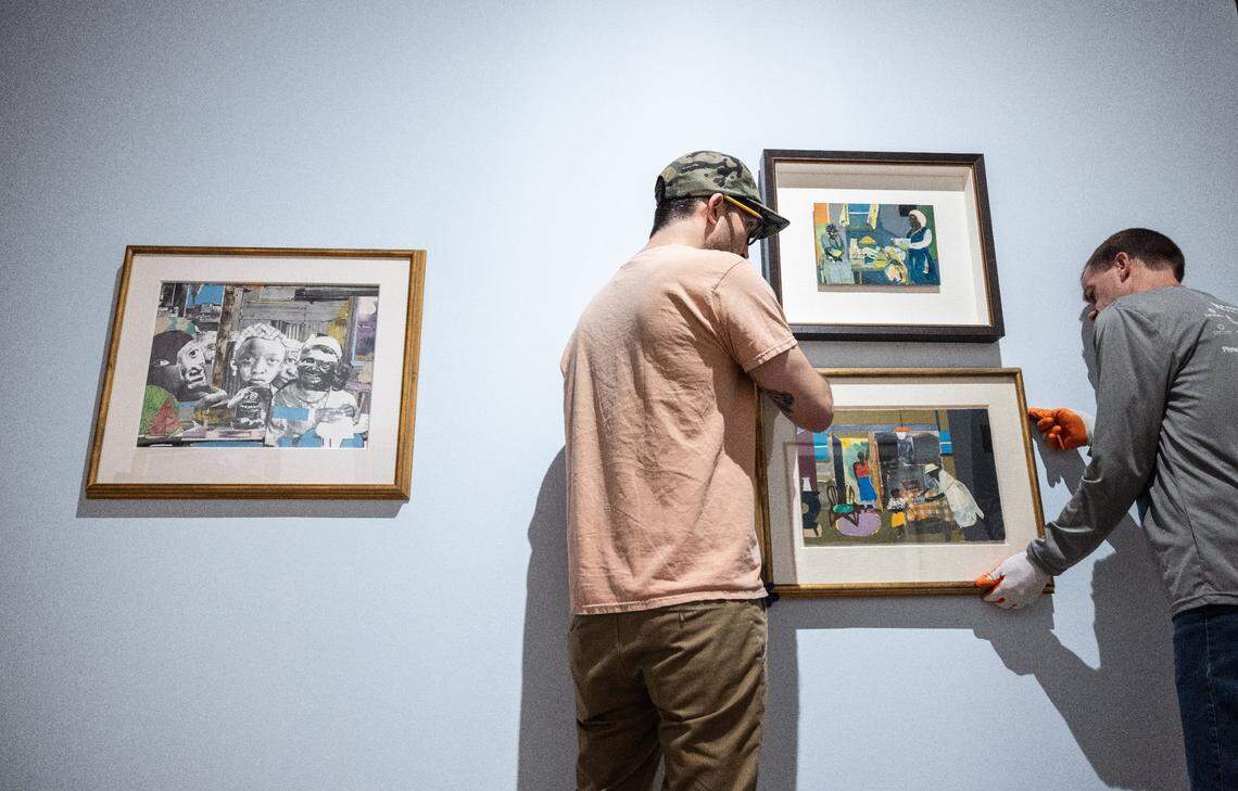 Workers carefully hang one of the paintings for the “Bearden/Picasso: Rhythms and Reverberations”  exhibition opening Feb. 11 at Mint Museum Uptown. The exhibit shows the connection&nbsp;between artists Pablo Picasso and Charlotte native Romare Bearden.