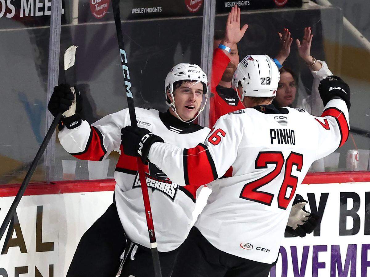 Charlotte Checkers forward Ben Steeves, left, is congratulated by forward Brian Pinho, right, following Steeves’ goal during third period action against the Iowa Wild on Friday, October 17, 2025 at Bojangles Coliseum in Charlotte.