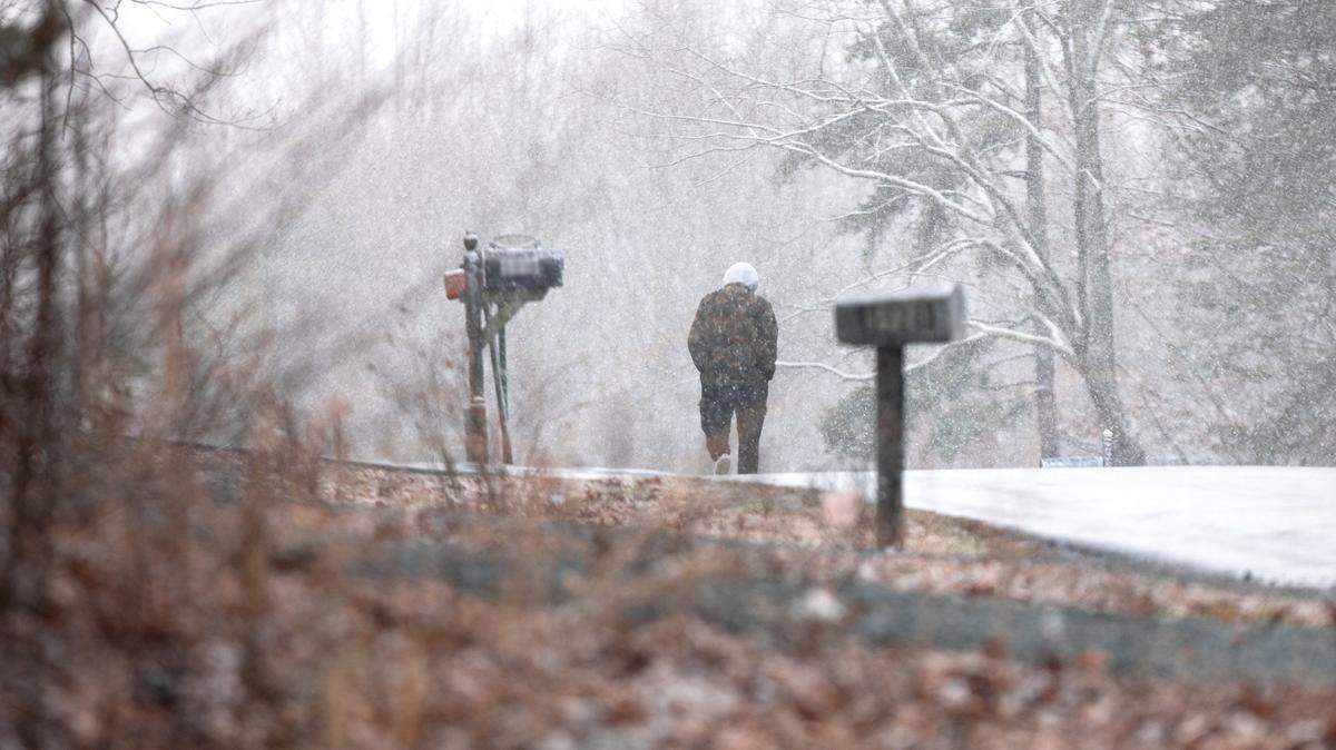 Charlotte-Mecklenburg Schools has enough hours left in its schedule for three more instruction days to be waived after cancellations for snow and severe weather. In this February file photo, a pedestrian walks along North Carolina Highway 73.