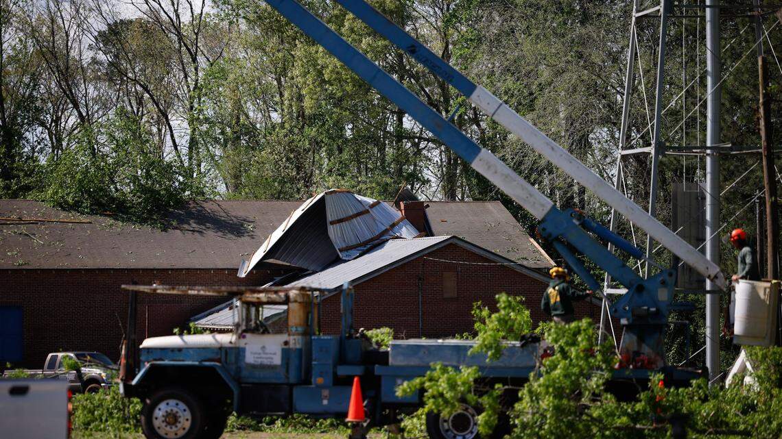 Severe storms last night caused several trees to fall on structures and causing damage on Friday, April 12, 2024. Crews work on removing parts of a tree that fell on the West Rowan YMCA gym behind Mt. Ulla Elementary School.