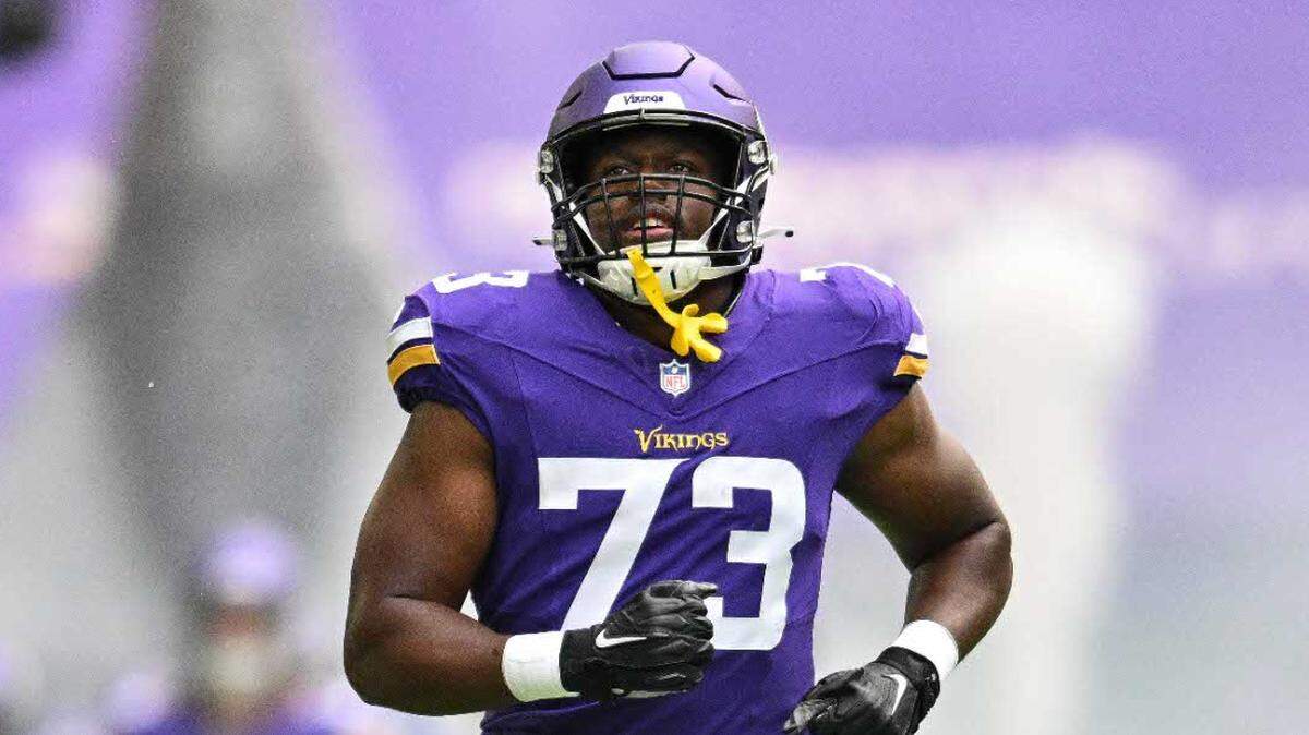 Defensive tackle Junior Aho, then with the Minnesota Vikings, enters the field before the game against the Arizona Cardinals at U.S. Bank Stadium in August 2023.