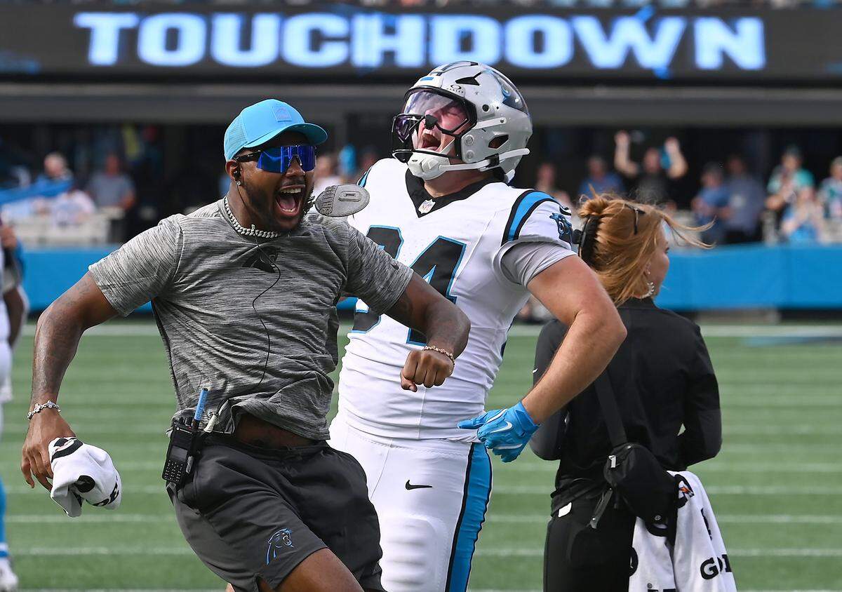 Carolina Panthers tight end Mitchell Evans, right, celebrates his touchdown pass reception with team personnel during fourth quarter action against the Miami Dolphins on Sunday, October 5, 2025 at Bank of America Stadium in Charlotte, NC. The Panthers defeated the Dolphins 27-24.