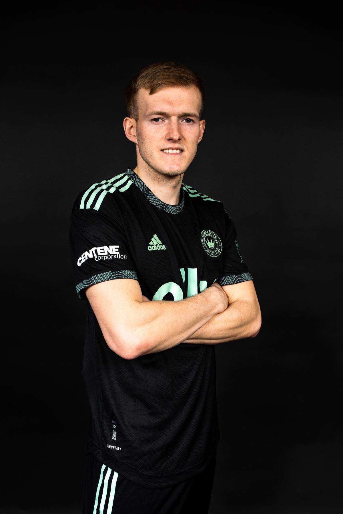 Charlotte FC striker Karol Świderski poses in the secondary kit that Charlotte FC players will wear during the team’s first Major League Soccer seasons.