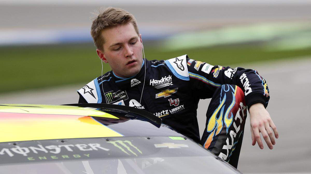 William Byron climbs out of his car after his qualifying run for the Daytona 500 at Daytona International Speedway on Sunday. Byron won the pole, and Hendrick Motorsports drivers took the top four spots.