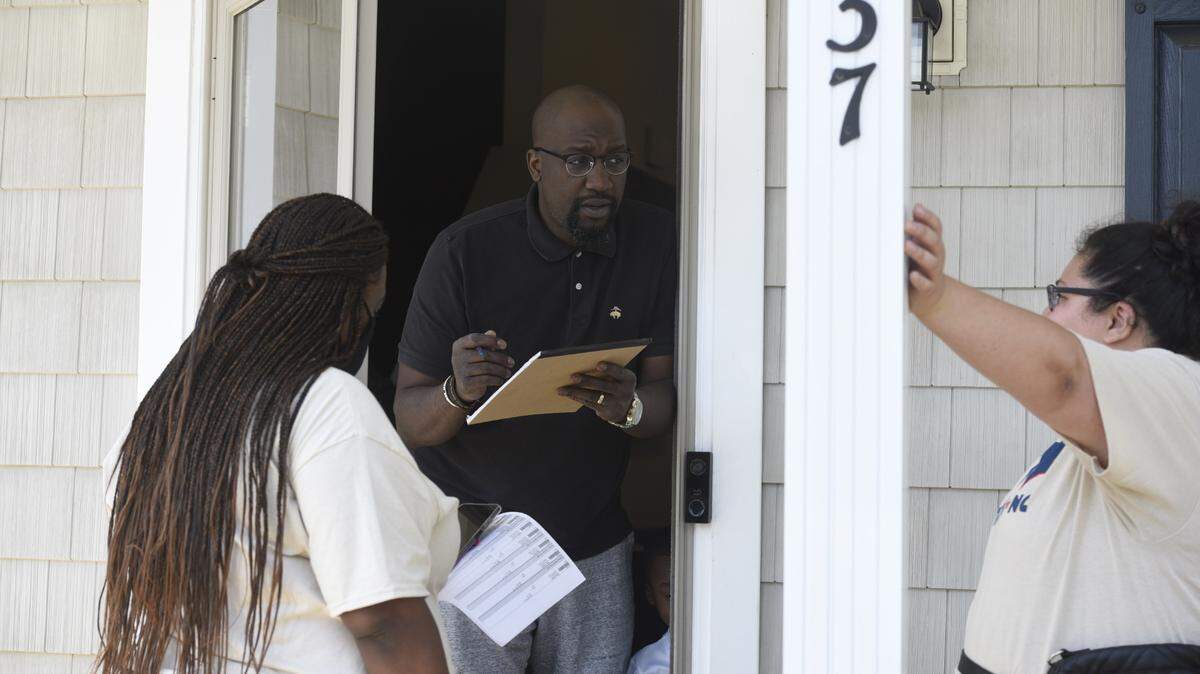 Jessica Moreno, Housing Justice Organizer, Action NC, right, talks with renter Bekai Cole about the needs for a national tenants union on Saturday April 23, 2022. Moreno and her team spend the day canvassing the neighborhood. On the left is Pattache Roper, a volunteer.