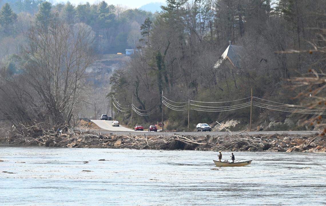 Two men fish the French Broad River in Asheville, NC on Wednesday, February 5, 2025. Businesses along the French Broad River incurred deep floodwaters during Hurricane Helene in late September 2024. Many businesses are trying to get repairs finished and replenish stock that was damaged or swept away.