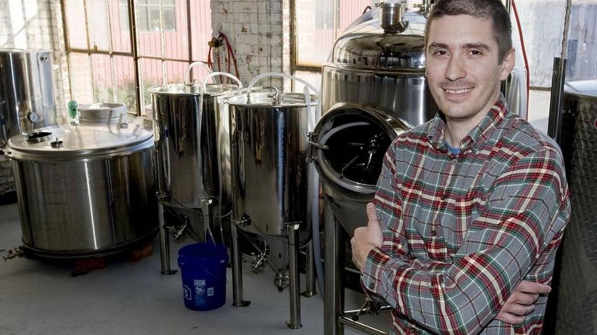 In this 2015 Charlotte Observer file photo, founder T.J. Creighton poses for a portrait with the fermenters in the brewing room before the opening of High Branch Brewing Co., the first brewery and taproom to open in Concord.