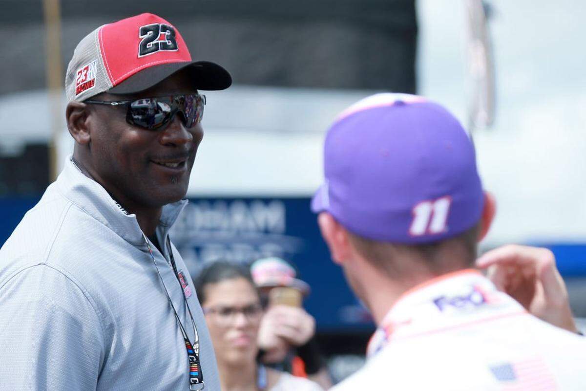 Michael Jordan meets with the co-owner of 23XI Racing, Denny Hamlin, driver of the No. 11 FedEx Ground Toyota, prior to the NASCAR Cup Series Pocono Organics CBD 325 in 2021 at Pocono Raceway in Pennsylvania.