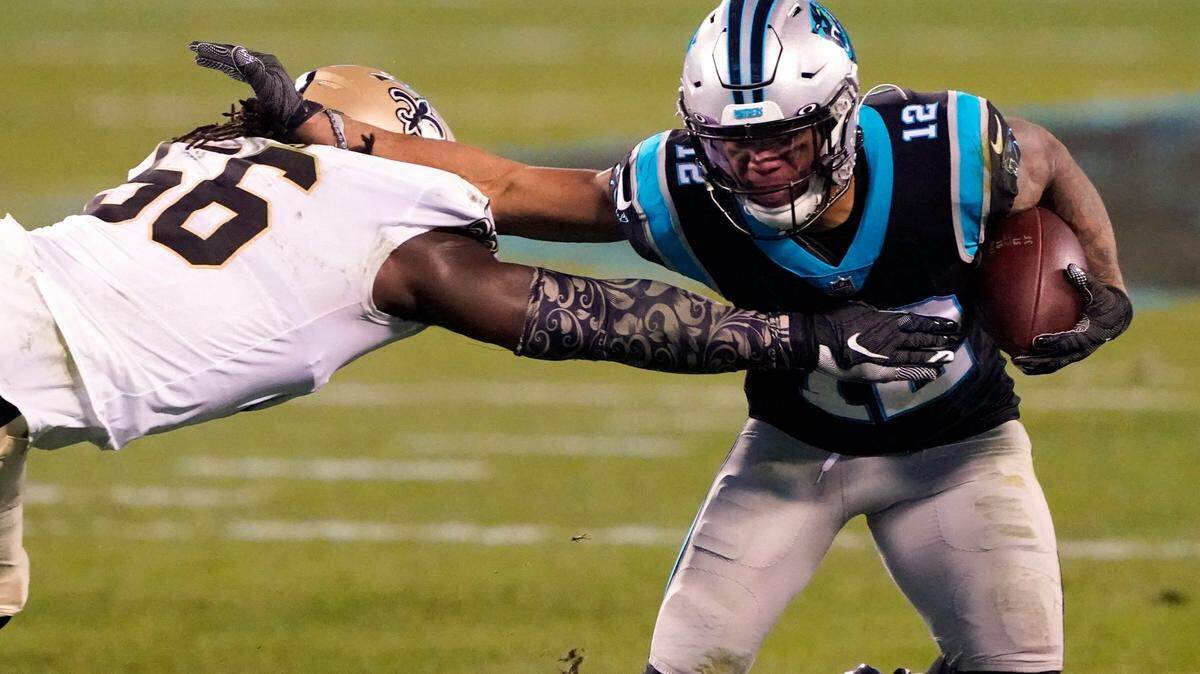 Carolina Panthers wide receiver D.J. Moore, right, runs around New Orleans Saints outside linebacker Demario Davis during the first half of an NFL football game Sunday, Jan. 3, 2021, in Charlotte, N.C. (AP Photo/Brian Blanco)