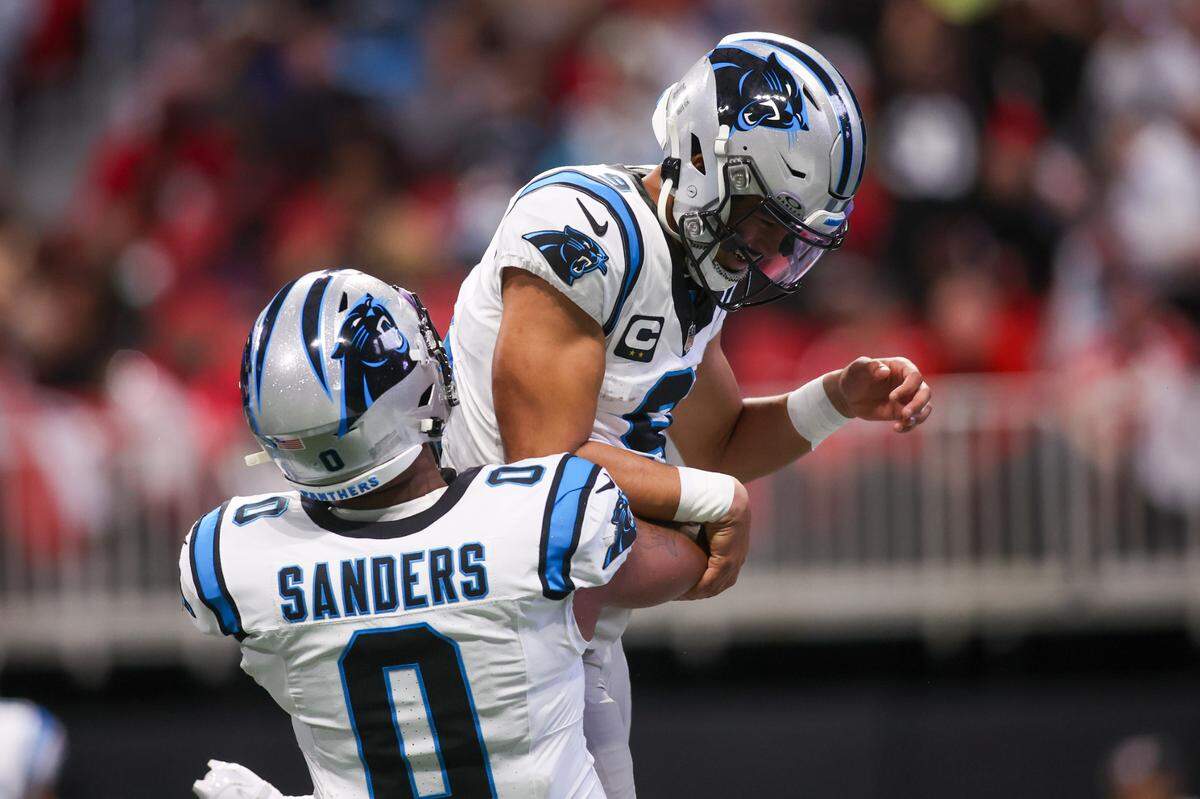 Carolina Panthers quarterback Bryce Young (9) celebrates with tight end Ja’Tavion Sanders (0) after a touchdown run against the Atlanta Falcons in Sunday’s second quarter at Mercedes-Benz Stadium.