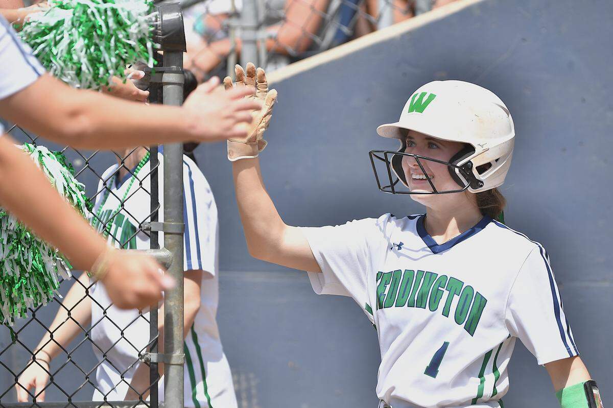 Weddington’s Samy Lamantia (1) celebraes with teammates in the dugout after a play in the first inning. The Garner Trojans and the Weddington Warriors met in the NCHSAA 4A Softball Championship Series in Greensboro, N.C. on June 1, 2024.