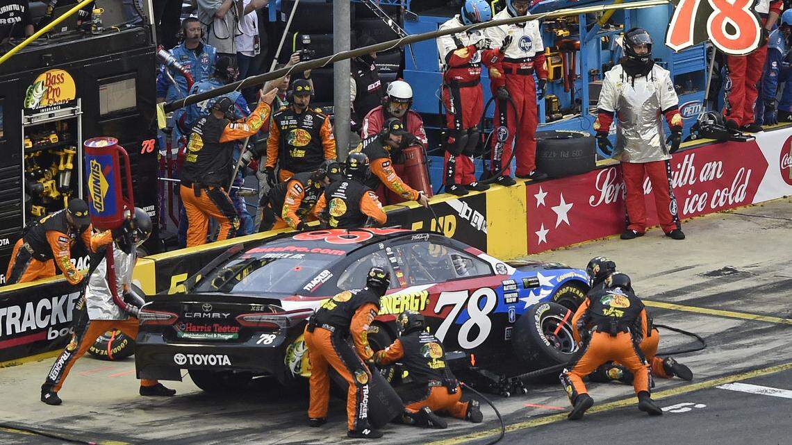 Crew members work on driver Martin Truex Jr.'s car during a Coca-Cola 600 pit stop. He won the race for second but had nothing for winner Kyle Busch.