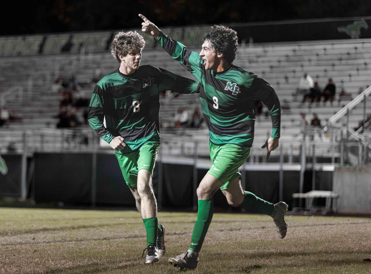 Myers Park forward Oliver Badir (center) celebrates his goal during 1st half action. Myers Park would host West Cabarrus in the 1st round of the NCHSAA high school soccer playoffs Saturday November 9, 2024.