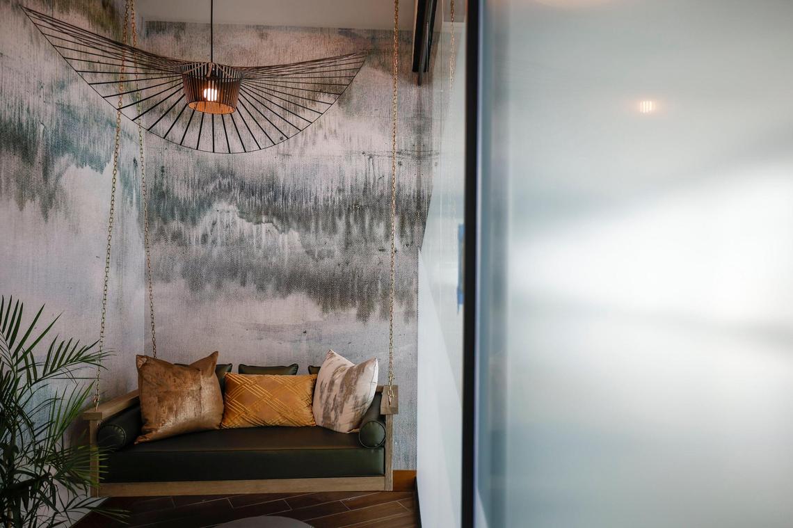 A swinging bench greets customers near the entrance of The Club CLT at Charlotte Douglas International Airport.