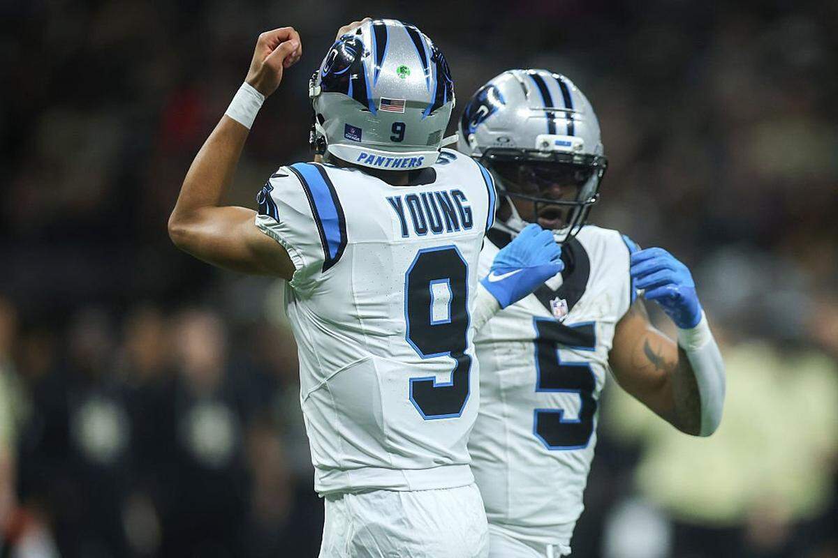 NEW ORLEANS, LOUISIANA - DECEMBER 14: Rico Dowdle #5 of the Carolina Panthers celebrates with teammate Bryce Young #9 after scoring a touchdown during the first quarter against the New Orleans Saints at Caesars Superdome on December 14, 2025 in New Orleans, Louisiana. (Photo by Chris Graythen/Getty Images)