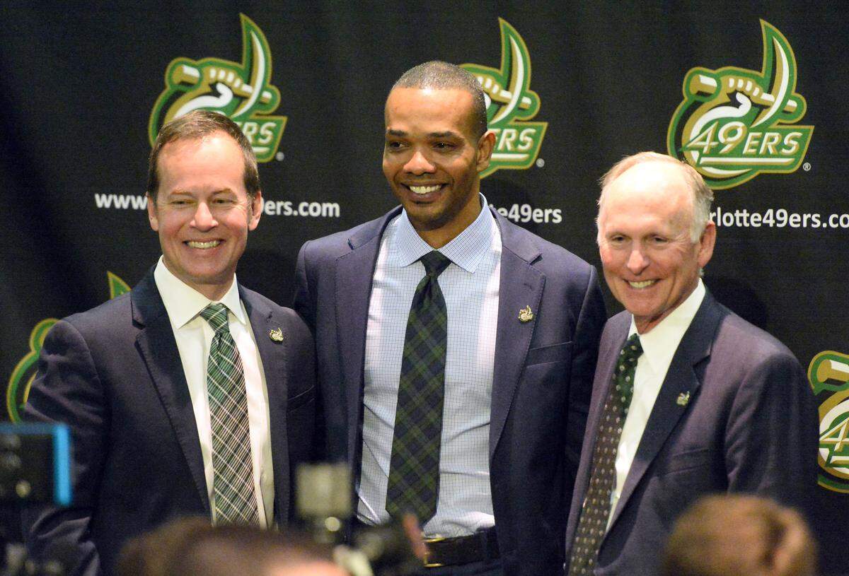 New Charlotte 49ers basketball coach Ron Sanchez (center) accepted the job without first touring the campus. He is flanked by new Charlotte athletic director Mike Hill (left) and the school's chancellor, Philip Dubois.