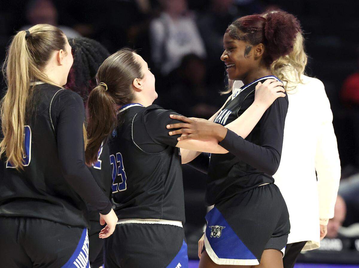 Members of the Lake Norman girls basketball team reach out to congratulate Kaiya Bond, right, during the girls NCHSAA 4A State Championship game against Wakefield on Saturday, March 15, 2025 at Lawrence Joel Veterans Memorial Coliseum in Winston-Salem, NC. Lake Norman defeated Wakefield 43-41.
