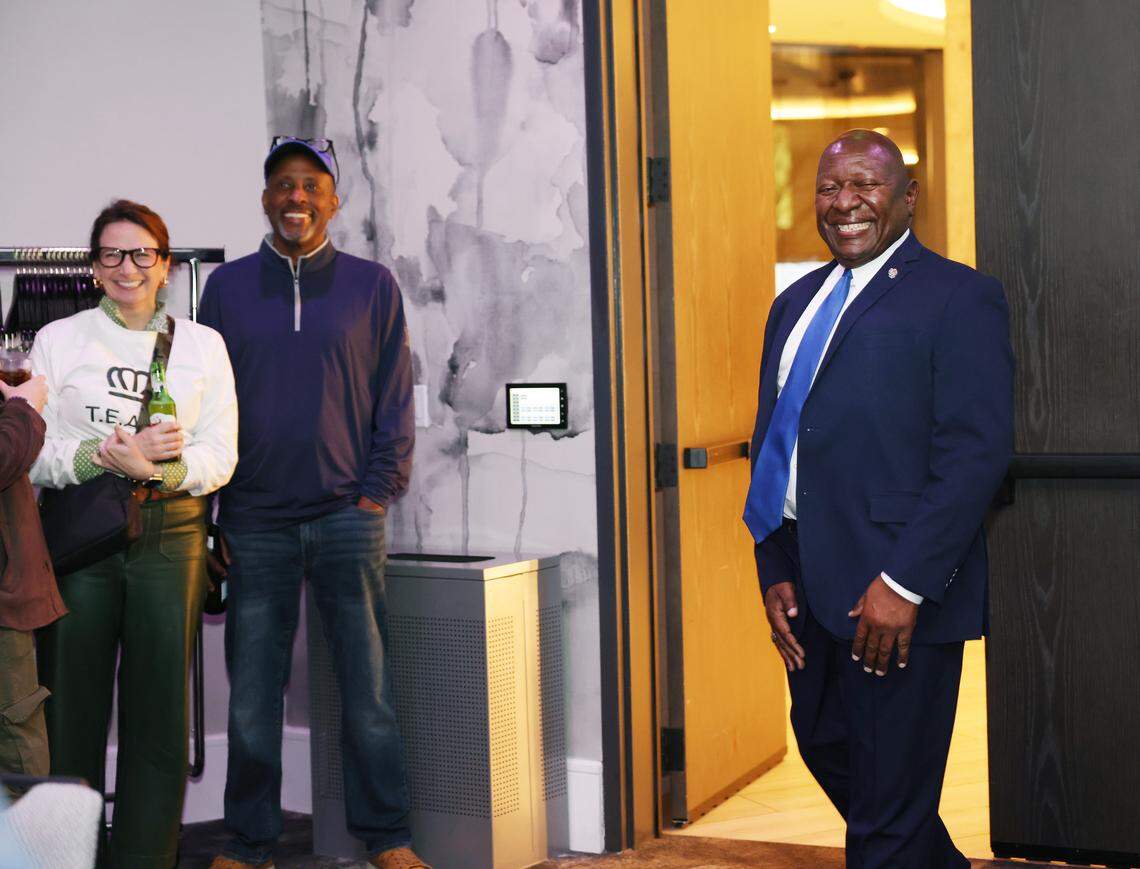 Ricky Robbins, right, a candidate for sheriff of Mecklenburg County, enters an event room filled with supporters Tuesday at Hyatt Centric.