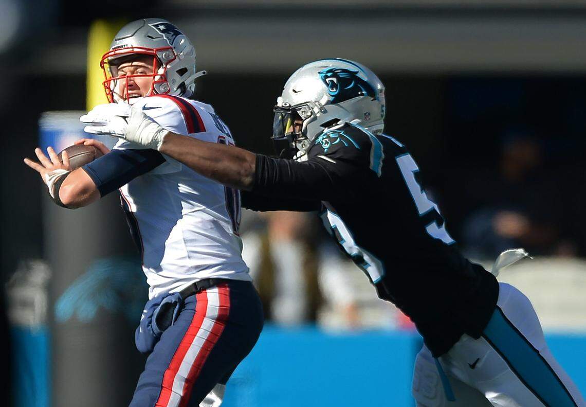 Carolina Panthers defensive end Brian Burns, right, sacks New England Patriots quarterback Mac Jones, left, during first quarter action at Bank of America Stadium in Charlotte, NC on Sunday, November 7, 2021.