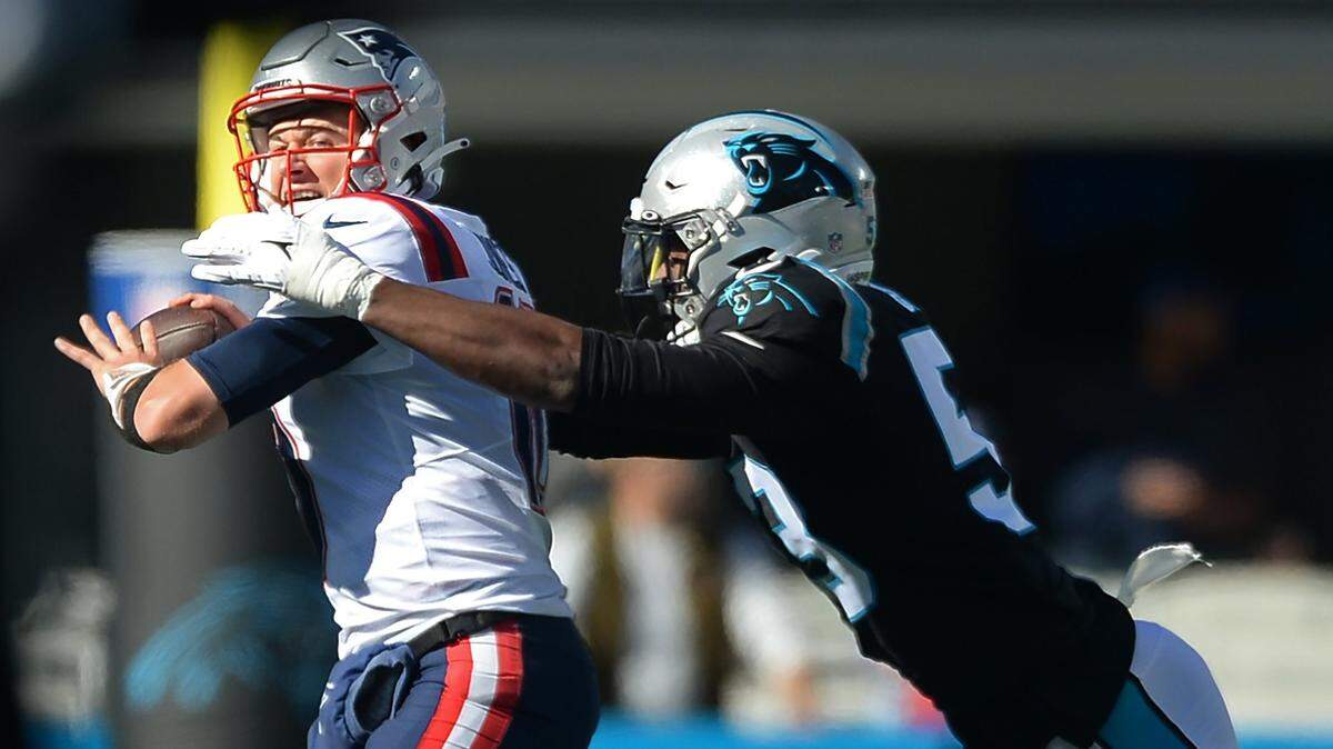 Carolina Panthers defensive end Brian Burns, right, sacks New England Patriots quarterback Mac Jones, left, during first quarter action at Bank of America Stadium in Charlotte, NC on Sunday, November 7, 2021.