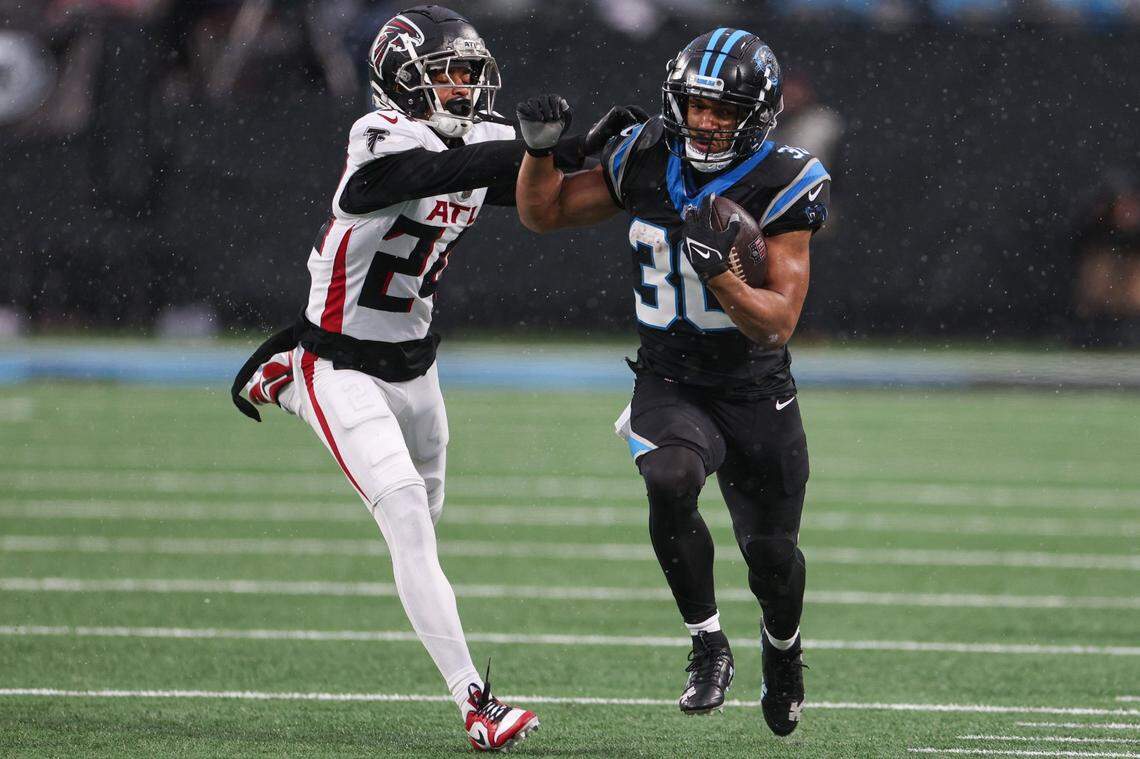 Panthers runningback Chuba Hubbard, right, is chased by Falcons cornerback A.J. Terrell, Jr. during the game at Bank of America Stadium on Sunday, December 16, 2023.