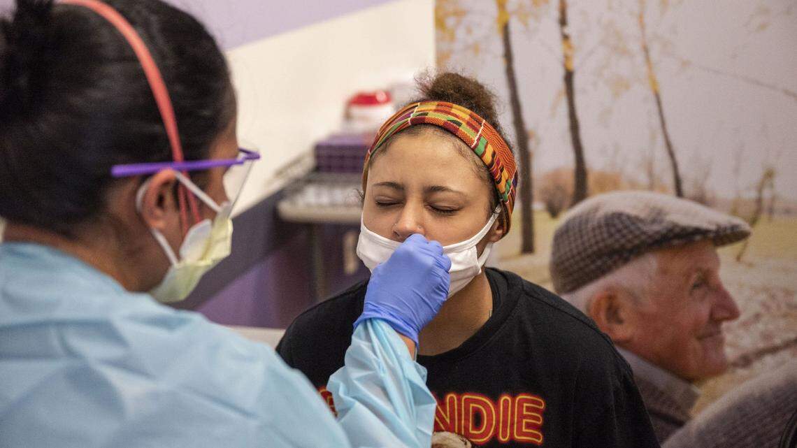Alyssa Baker, right, winces as she gets swabbed for COVID-19 at the Novant Health East Meck on Sept. 8, 2021 in Charlotte. Baker came in to get tested as a preemptive measure ahead of attending social situations including a baby shower and a vacation.