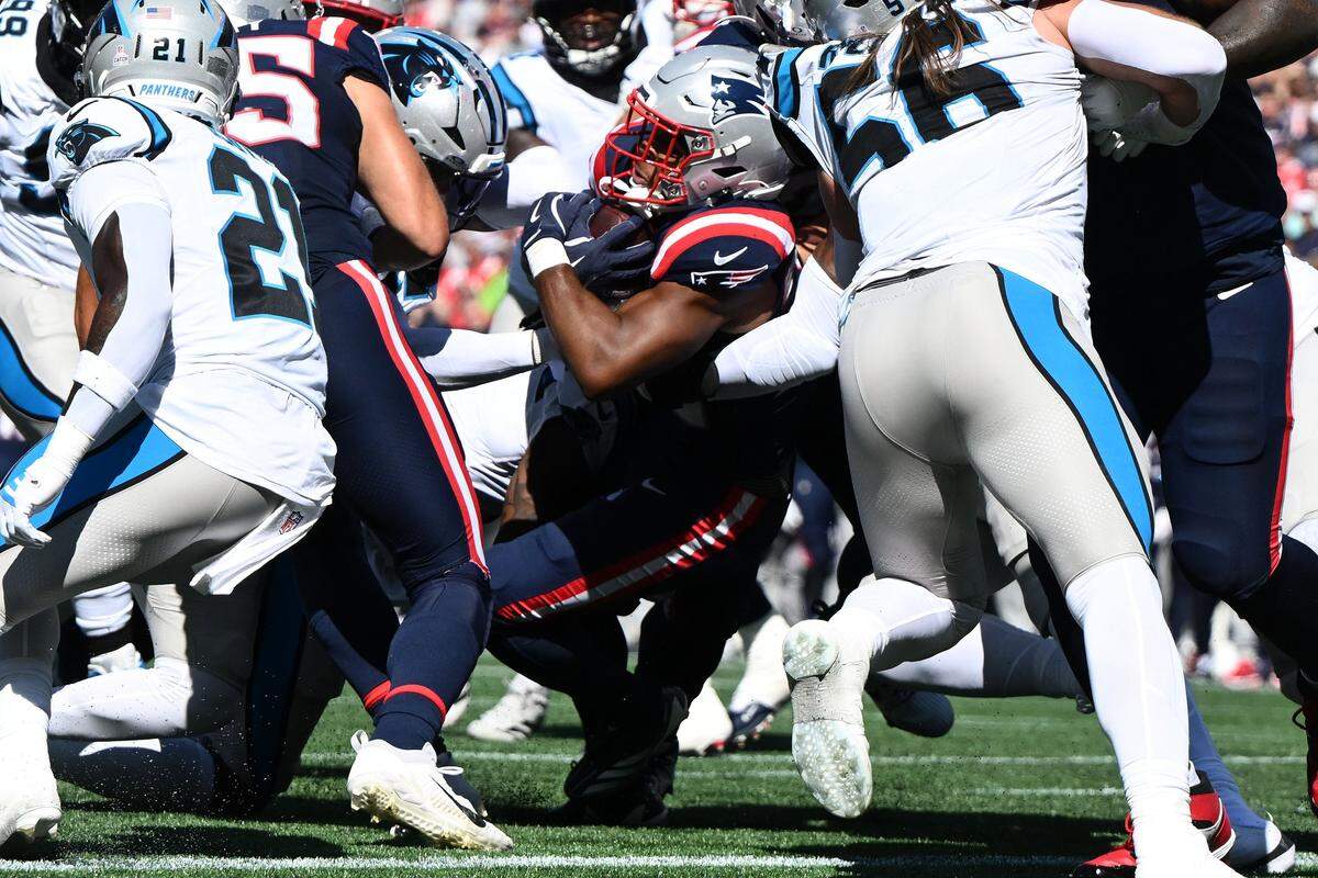 New England Patriots running back Treveyon Henderson (32) scores a touchdown against the Carolina Panthers during Sunday’s first half at Gillette Stadium.