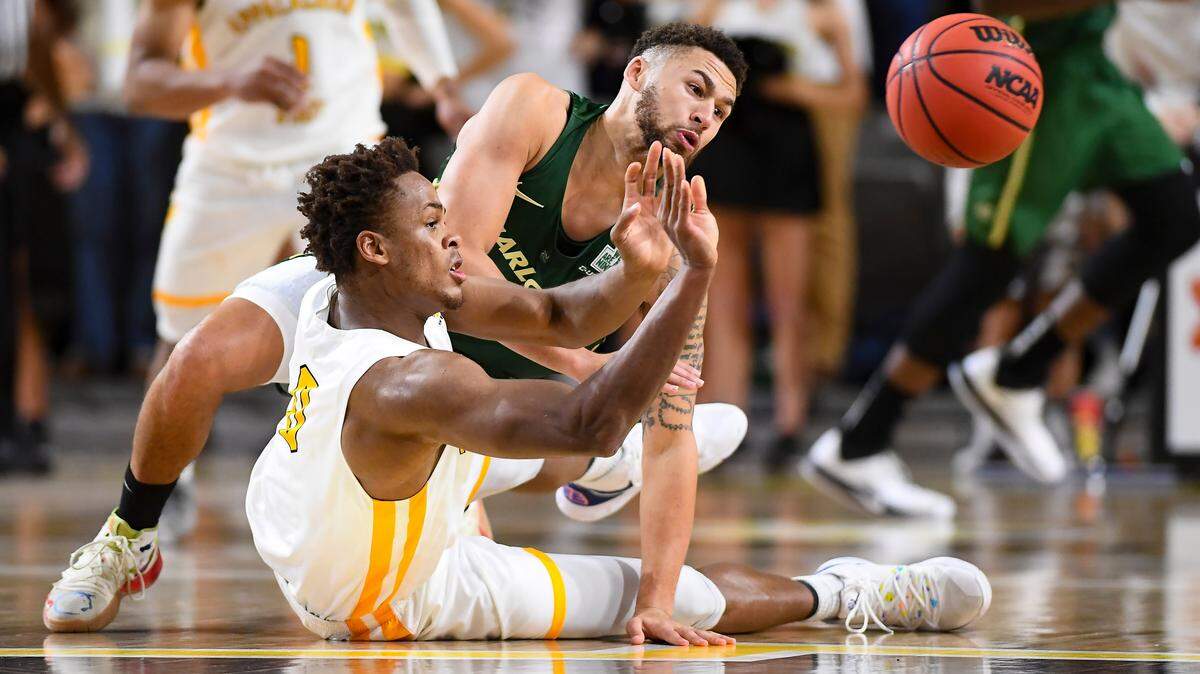 Isaac Johnson (0) of Appalachian State and Drew Edwards (25) of Charlotte fight for a loose ball.
