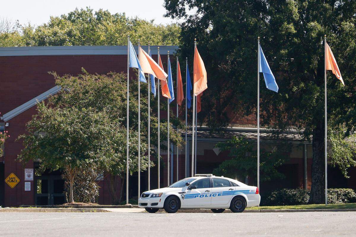 A Charlotte-Mecklenburg police cruiser is parked at Kennedy Middle School in Charlotte, N.C., Wednesday, Sept. 21, 2022. Olympic High, Kennedy Middle and Steele Creek Elementary were placed on lockdown following a bomb threat on Wednesday.