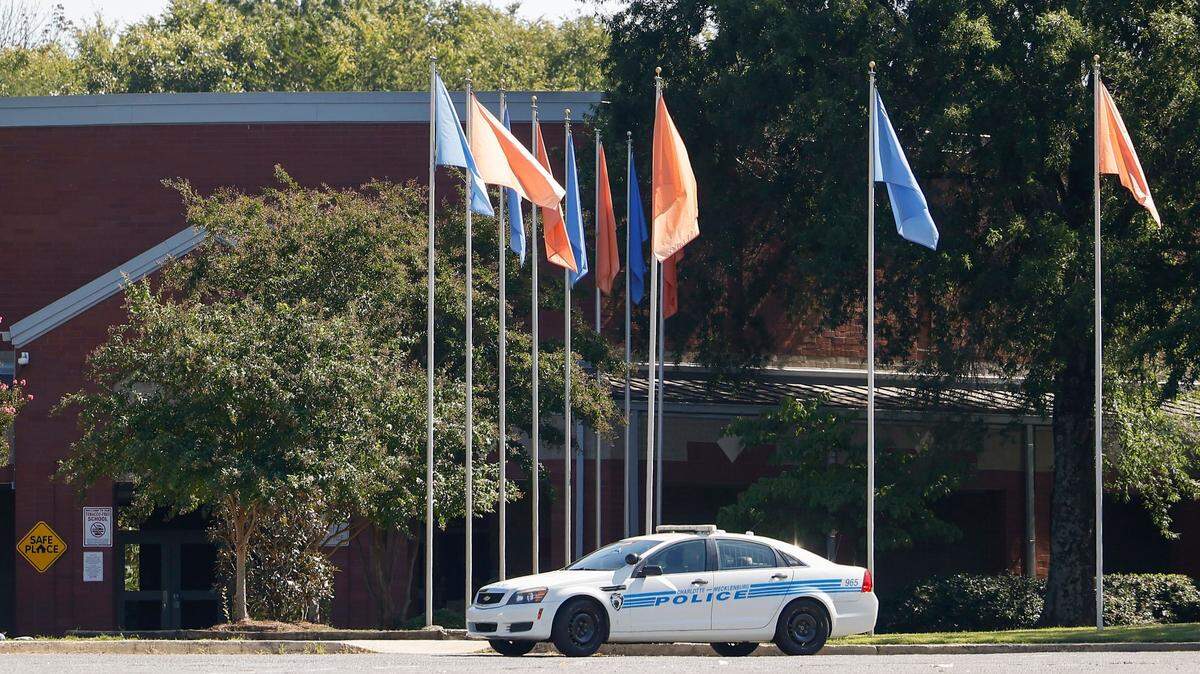 A Charlotte-Mecklenburg police cruiser is parked at Kennedy Middle School in Charlotte, N.C., Wednesday, Sept. 21, 2022. Olympic High, Kennedy Middle and Steele Creek Elementary were placed on lockdown following a bomb threat on Wednesday.