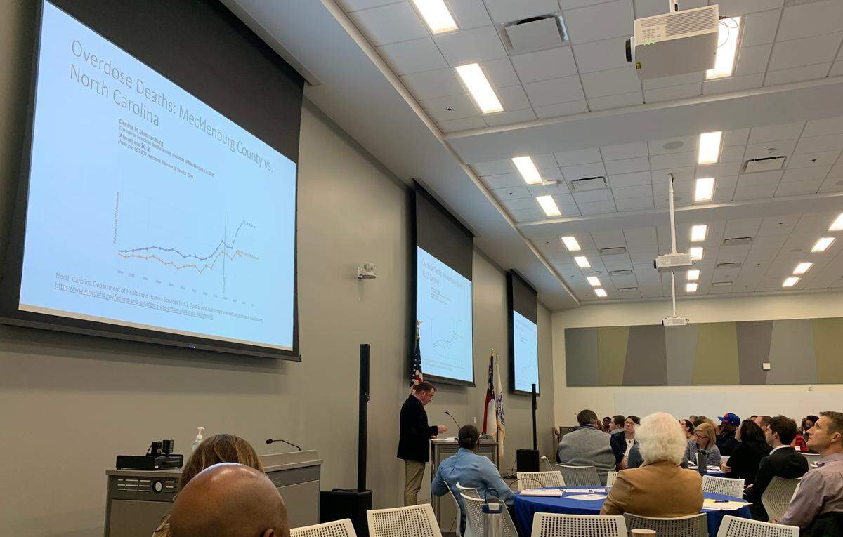 Travis Hales, assistant professor at the UNC Charlotte School of Social Work, speaks to community members and leaders about overdose deaths in Mecklenburg County and North Carolina on Thursday, Oct. 27, 2022.