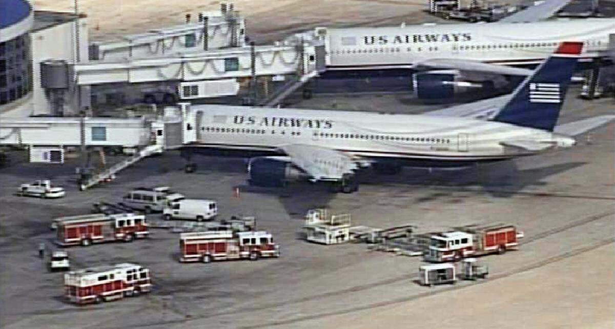 Emergency vehicles surround a US Airways jet Tuesday at Charlotte/Douglas airport. WCNC.COM