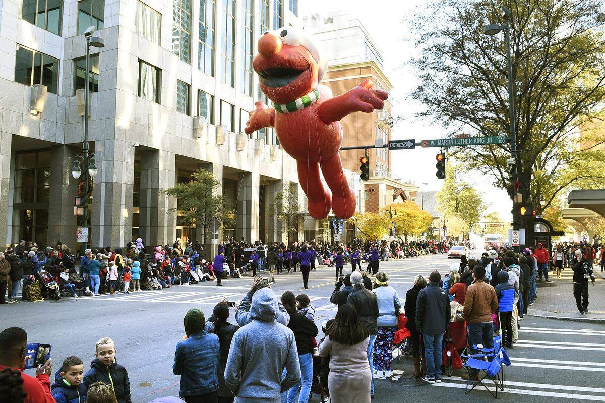 A giant Elmo balloon gets some help as it wiggles past street lights and trees along Tryon Street during the 2017 Novant Health Thanksgiving Day Parade in uptown Charlotte. This year’s parade is set for the night before Thanksgiving, and temperatures are expected to drop into the 40s.