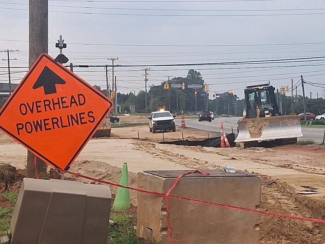 Signs warned of overhead power lines, as crews with Charlotte-based Lane Construction Corp. worked along U.S. 21 near Brawley School Road/West Wilson Avenue in Mooresville on Saturday, part of the state’s $51 million Brawley School Road widening project.