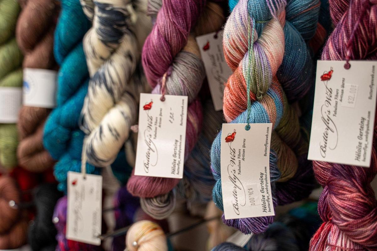 Colorful hanks of yarn are strewn about Remy Haygood’s Charlotte Yarn store in Dilworth.