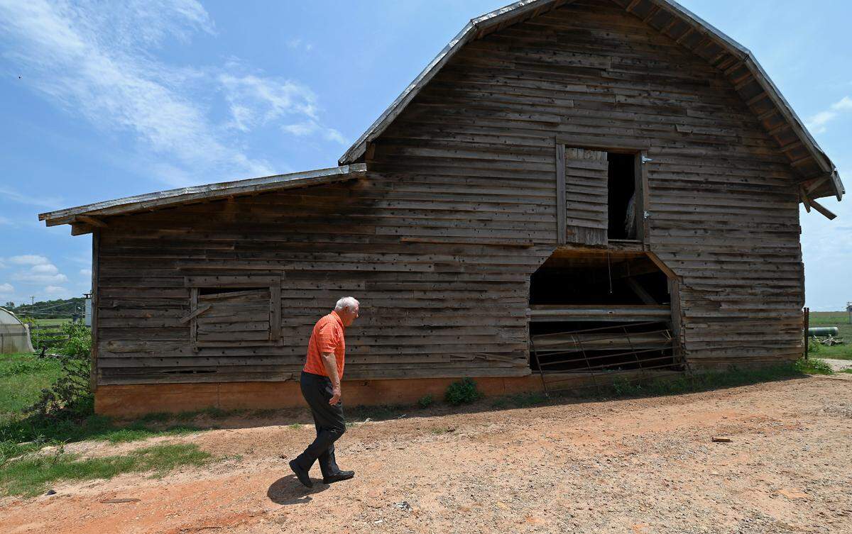 Former Clemson Tigers head football coach Danny Ford walks to a barn on his farm on Friday, July 22, 2022. Ford led the Tigers to a 12-0 season in 1981. Ford won ACC Coach of the Year in 1981 and was inducted into the College Football Hall of Fame in 2017.