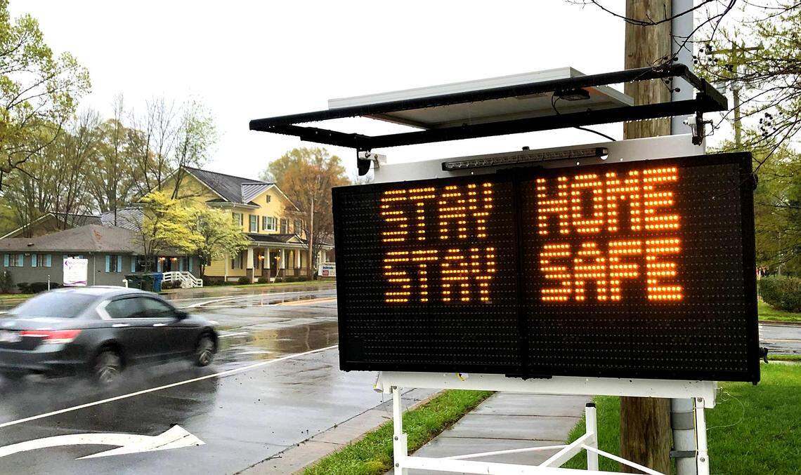 A mobile sign alerts drivers driving down John Street in Matthews, NC to “Stay Home, Stay Safe,” on Tuesday, March 24, 2020.