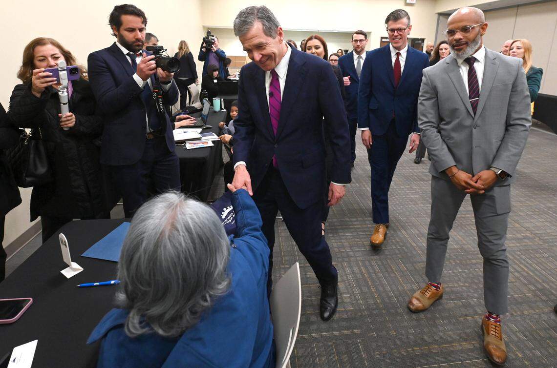 North Carolina Gov. Roy Cooper meets with navigators and clients following the announcement that Medicaid expansion started Friday.
