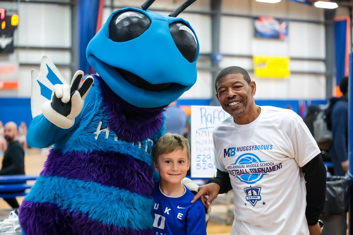 Muggsy Bogue poses with the Charlotte Hornets Mascot and fans at his third annual Muggsy Bogues’ middle school basketball tournament at Carolina Courts in Indian Trail, NC
