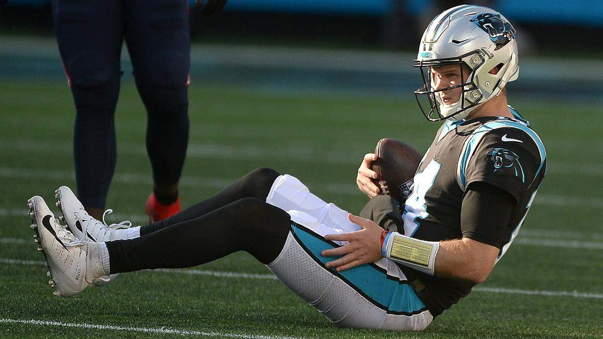 Carolina Panthers quarterback Sam Darnold sits on the turf after being tackled by New England Patriots linebacker Kyle Van Noy during fourth quarter action at Bank of America Stadium in Charlotte, NC on Sunday, November 7, 2021. The New England Patriots defeated the Panthers 24-6.