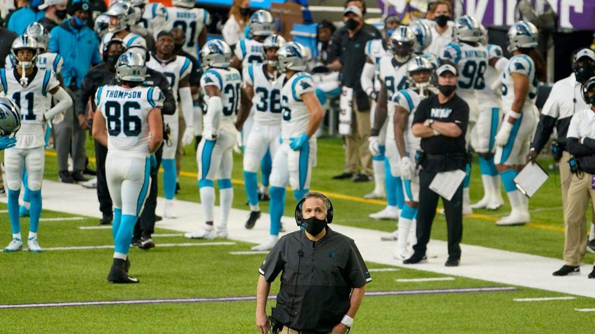 Carolina Panthers head coach Matt Rhule stands on the field during the second half of an NFL football game against the Minnesota Vikings, Sunday, Nov. 29, 2020, in Minneapolis. The Vikings won 28-27. (AP Photo/Jim Mone)