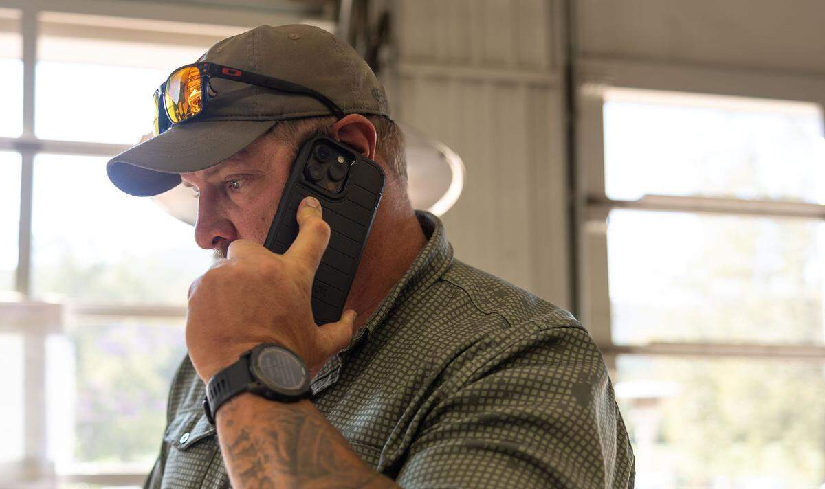 Adam Smith makes a phone call at Savage Operations Center inside of a Harley Davidson store in Swannanoa, N.C. on Tuesday, October 8, 2024.